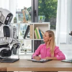 A woman speaks to a humanoid robot.